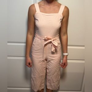 Baby pink jumpsuit goes just past the knees
